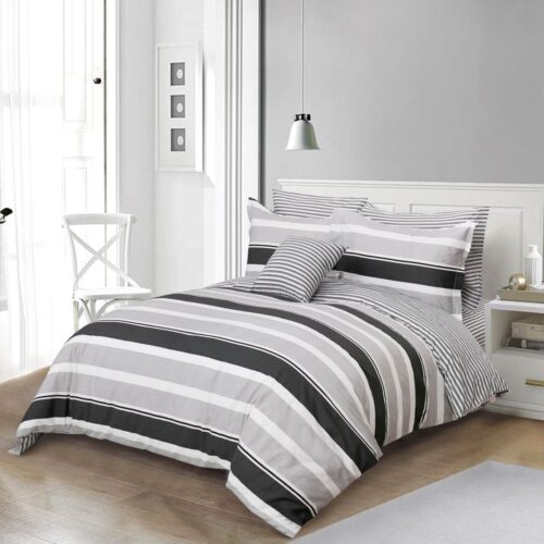 A bed with black and white striped sheets on it