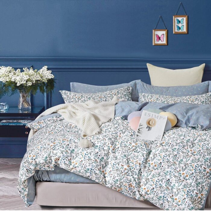 A bed with blue walls and white sheets