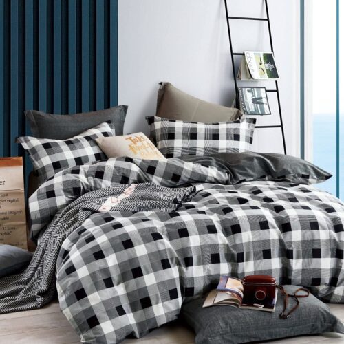 A bed with black and white checkered comforter.